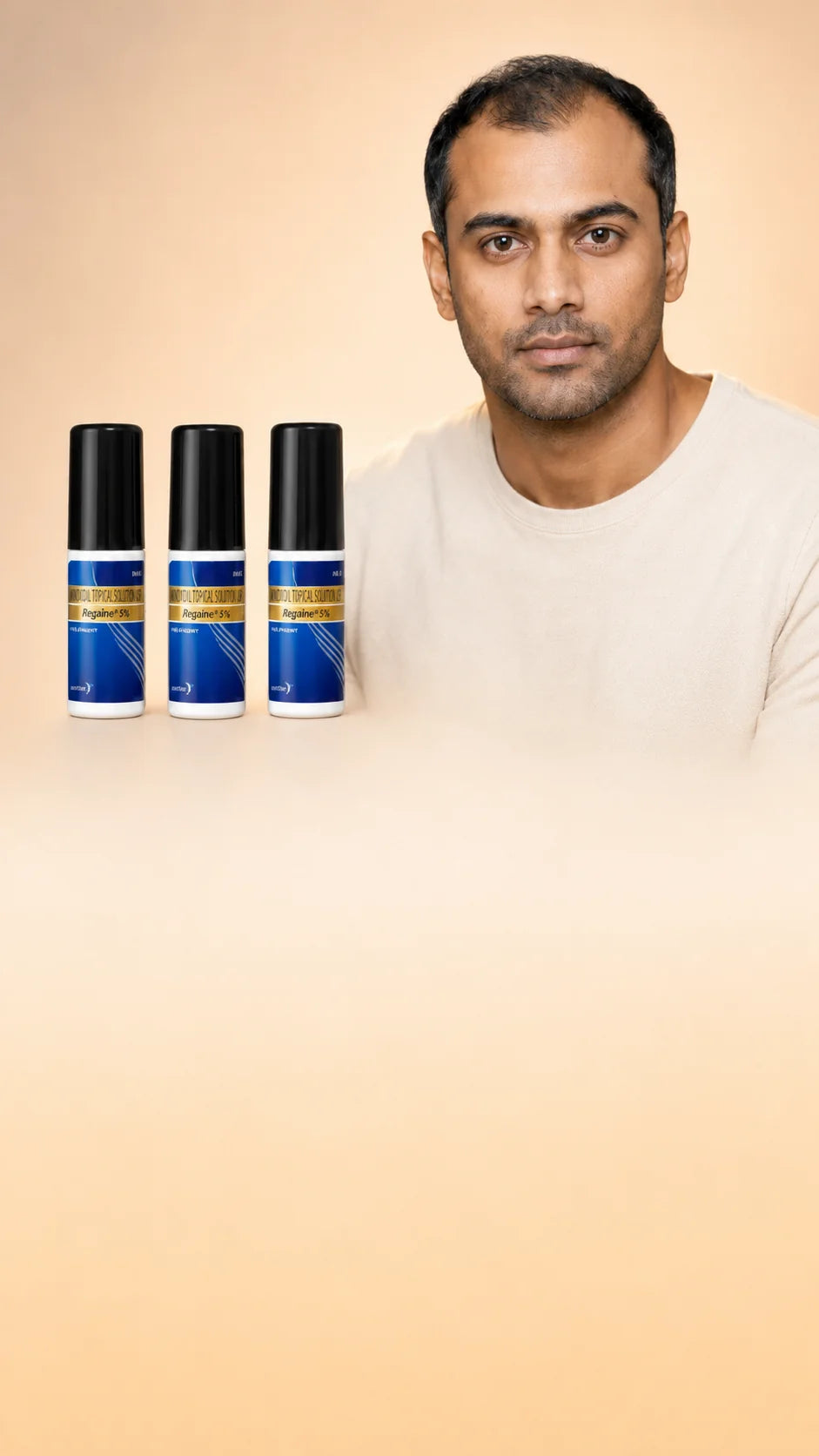 Rohan with three Regaine 5% minoxidil bottles — 3-month supply