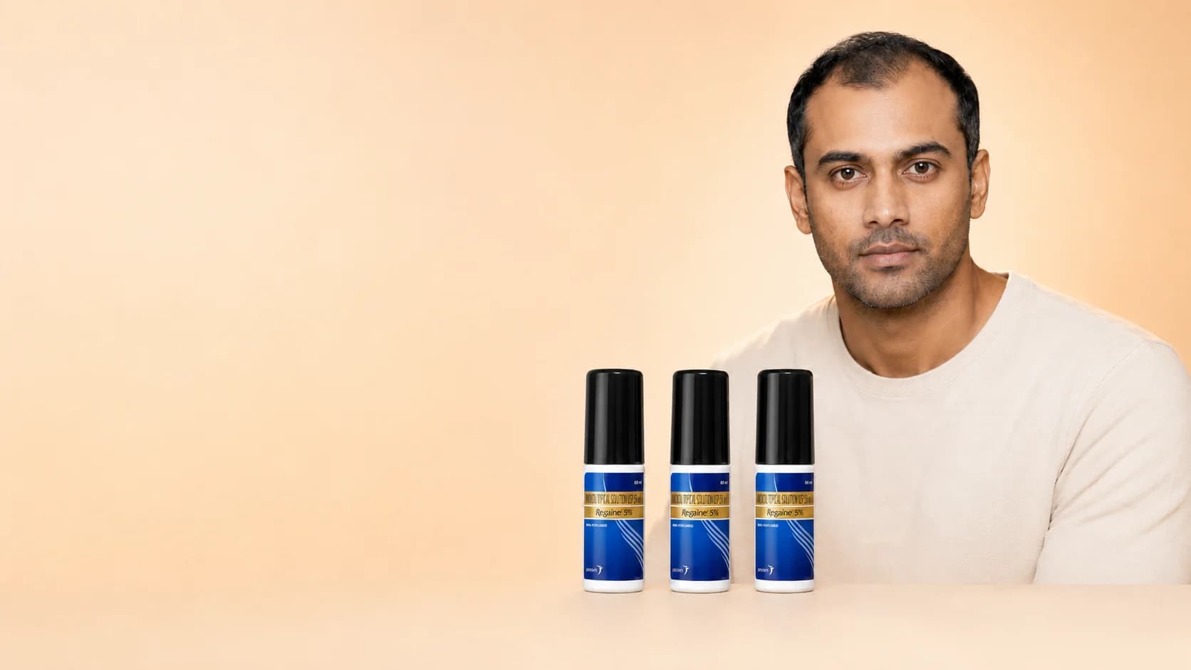 Rohan with three Regaine 5% minoxidil bottles — 3-month supply