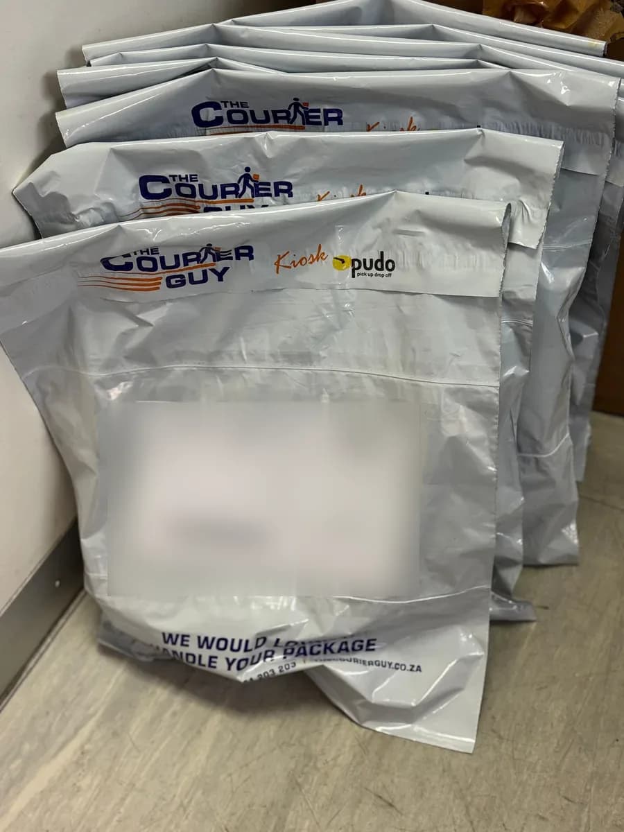 A stack of Skin Care Product orders packed in The Courier Guy bags, ready to ship across South Africa