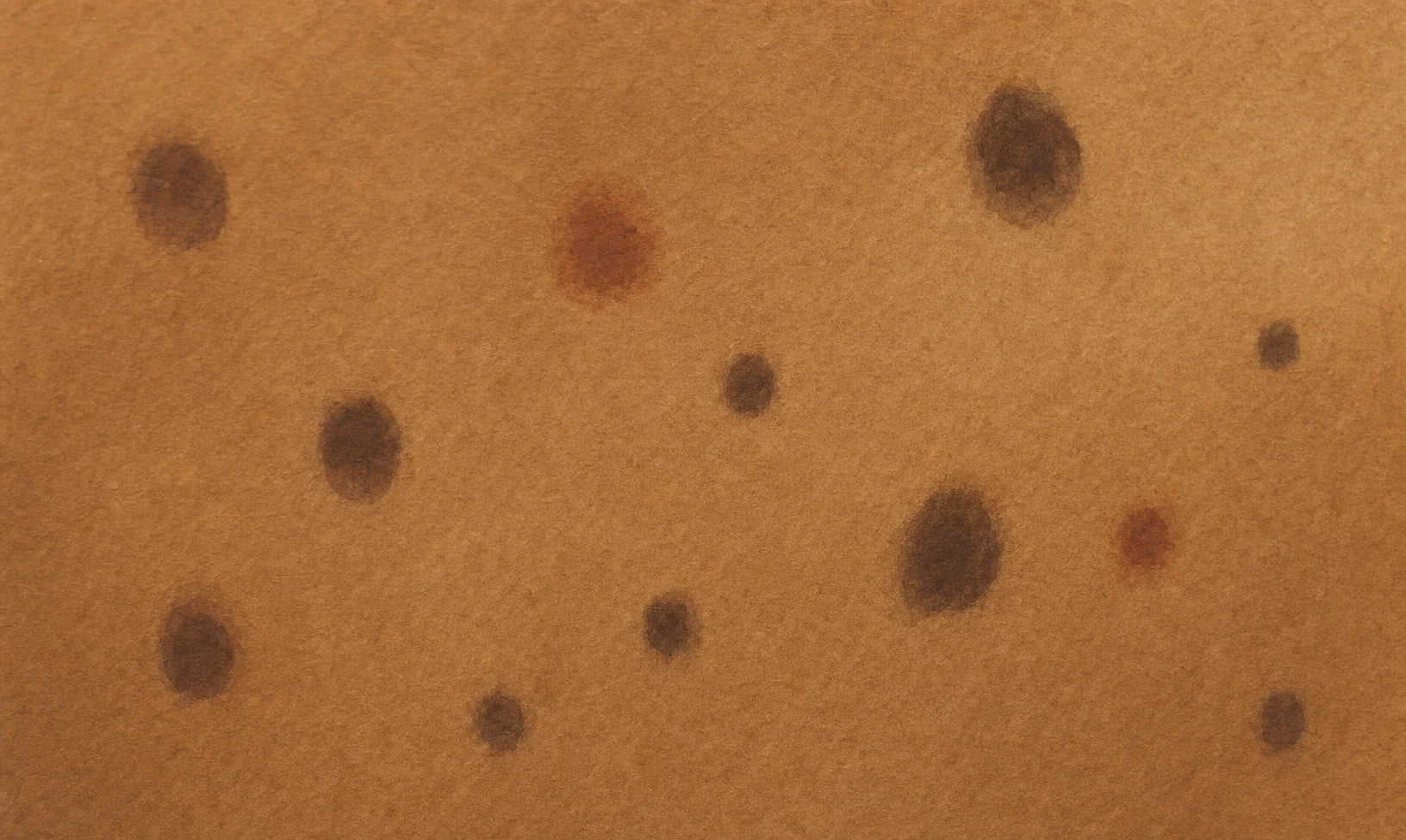 Skin swatch illustration showing post-inflammatory hyperpigmentation — scattered round dark marks of varying sizes on deeper tan skin